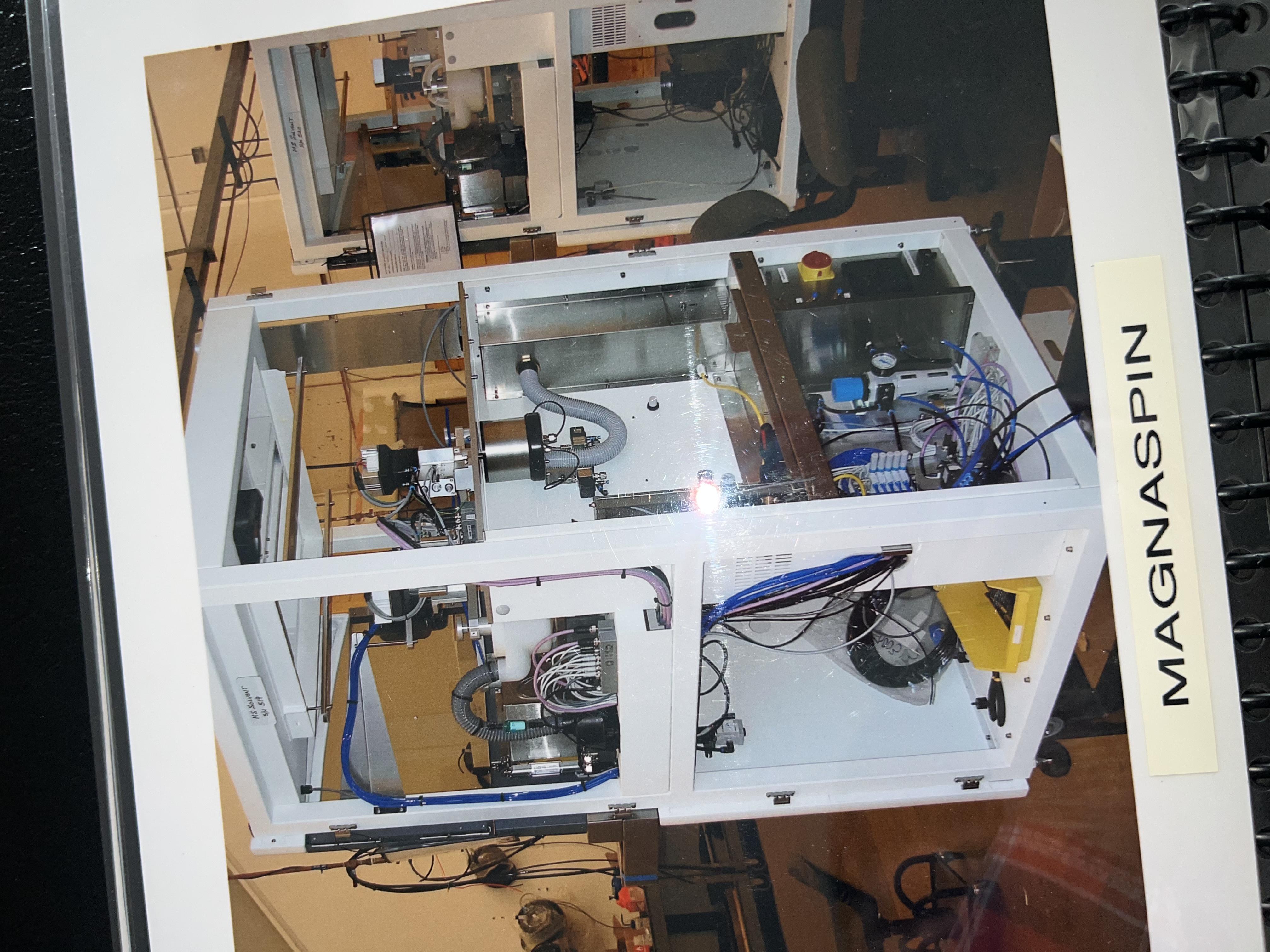 MAGNASPIN machine — precision optical lens processing system